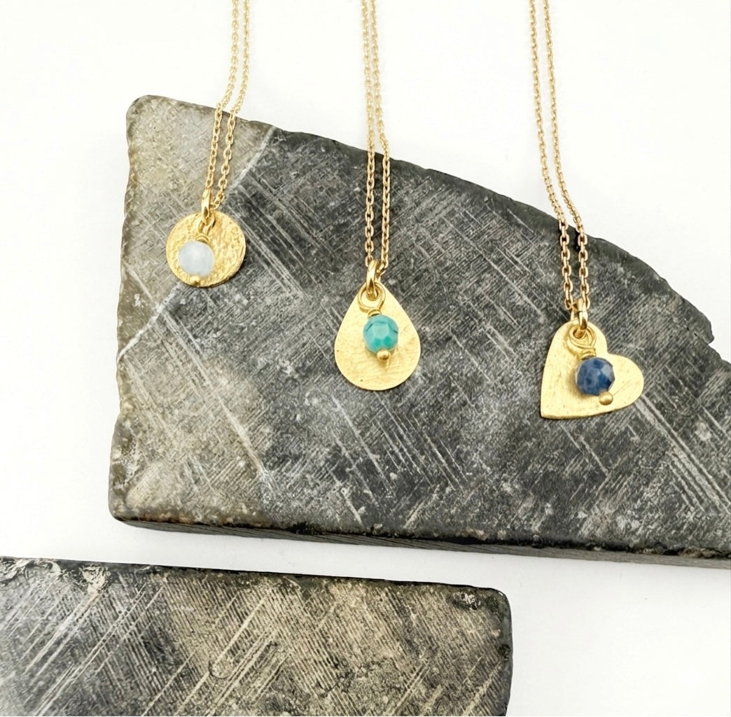 Three custom birthstone pendant necklaces in gold