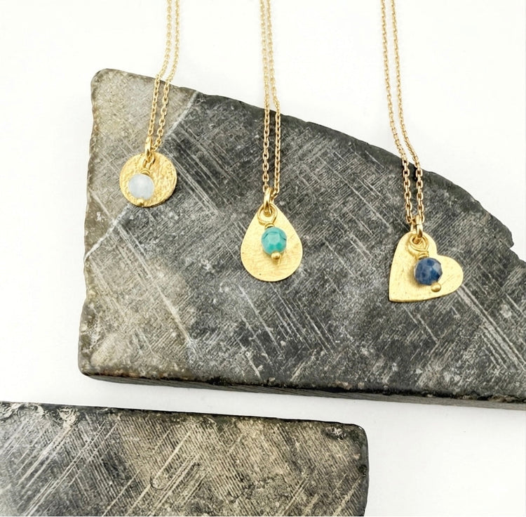 Three custom birthstone pendant necklaces in gold