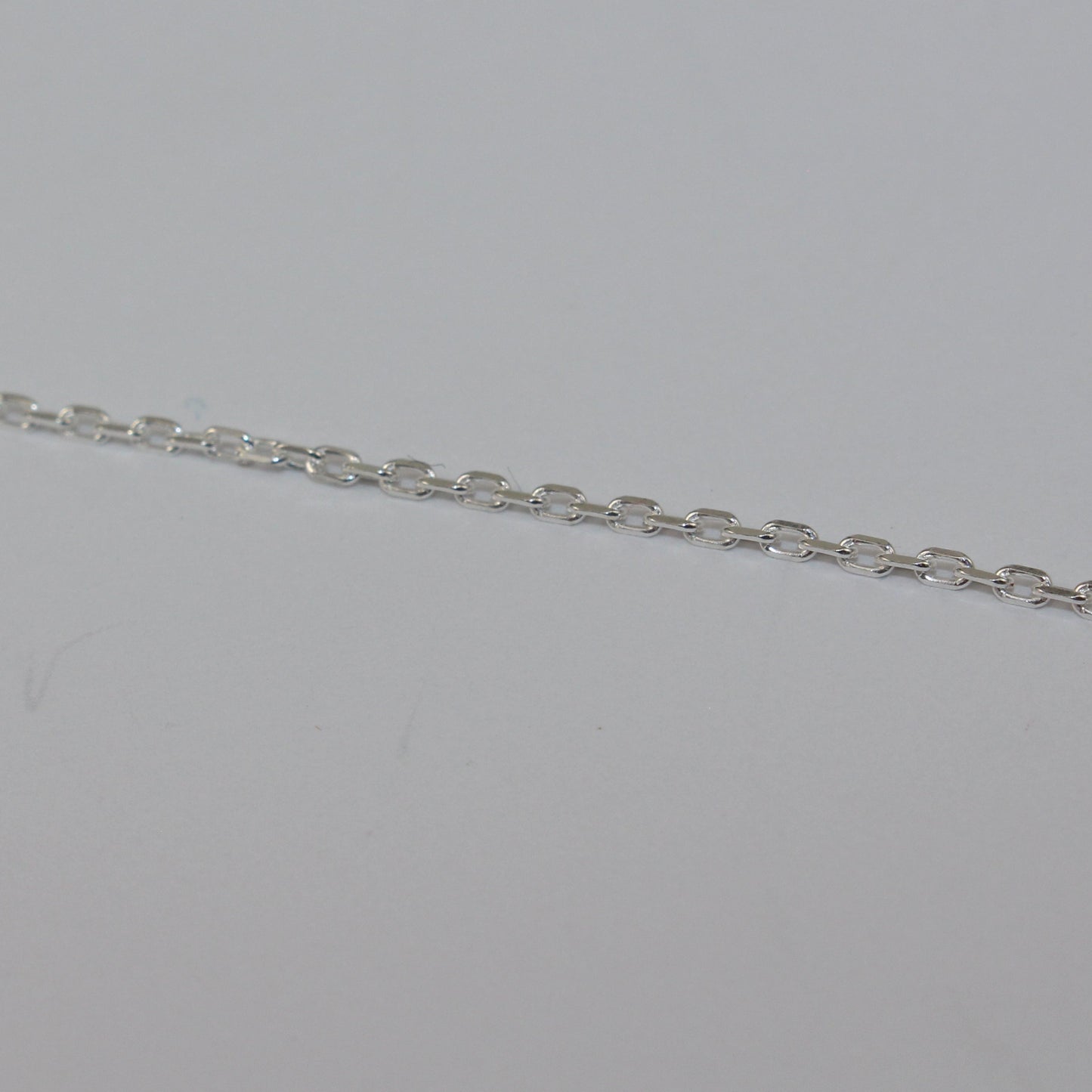 Silver chain on a light gray background