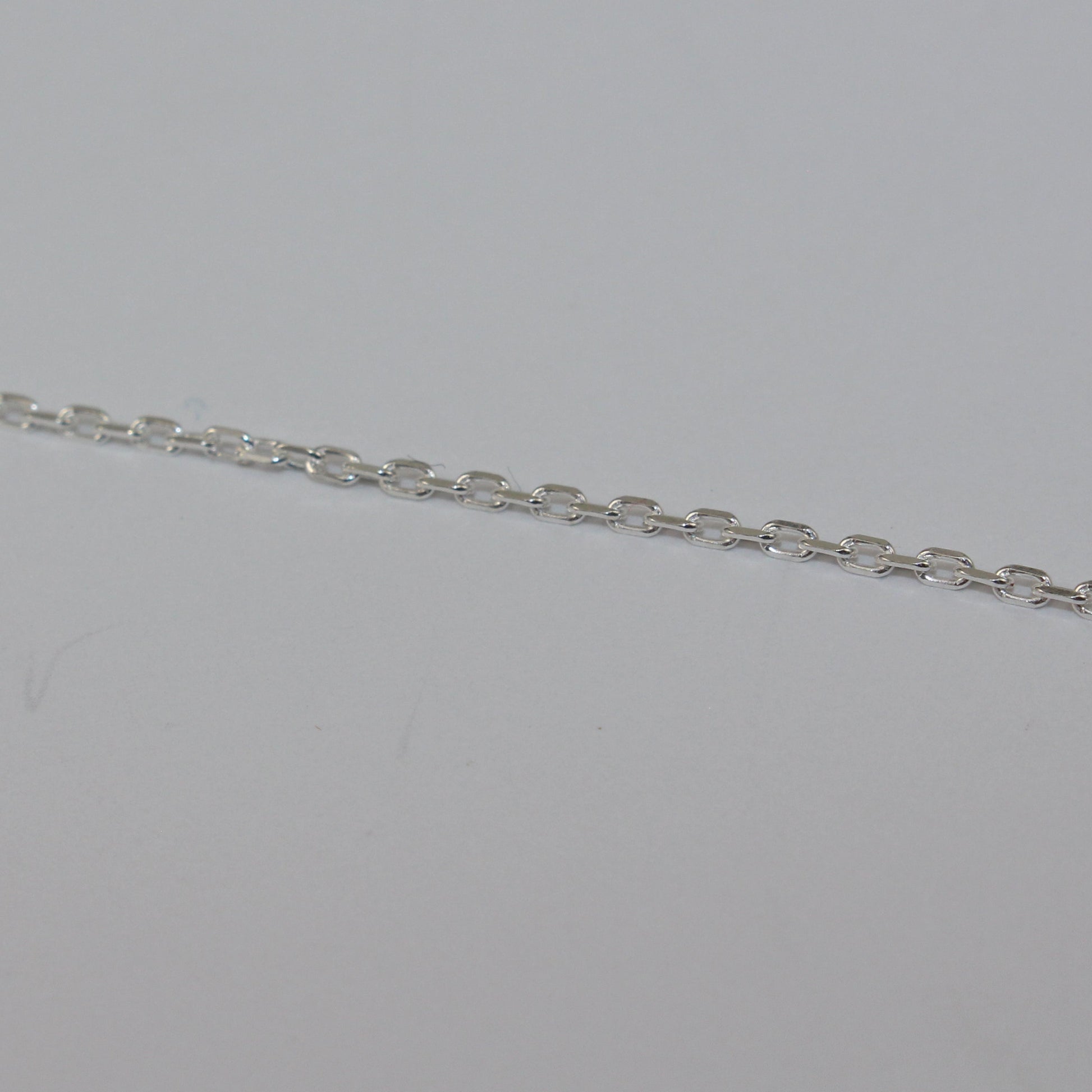 Silver chain on a light gray background