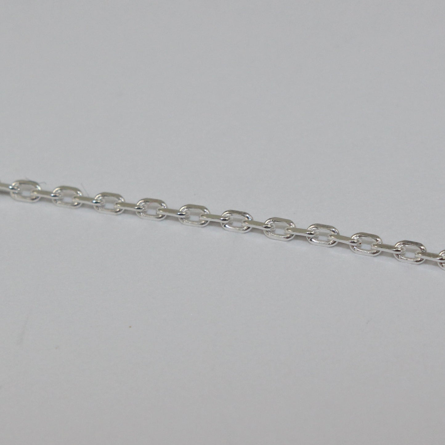 Silver chain on a light gray background
