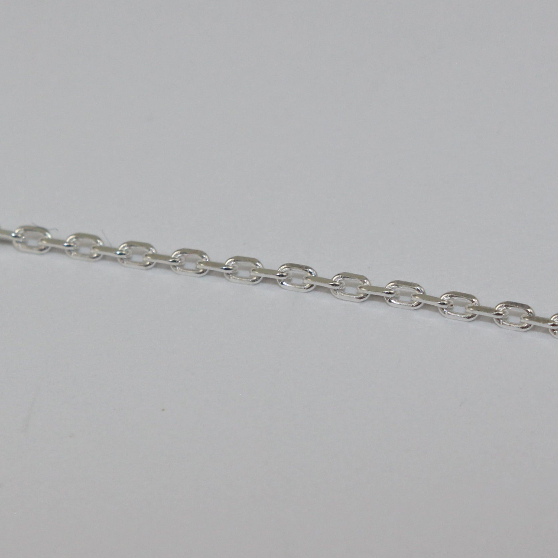 Silver chain on a light gray background